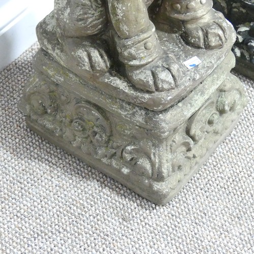 554 - Garden statuary; a pair of reconstituted stone figures of Dogs of Foo, each sat upon a plinth, 65cm ... 