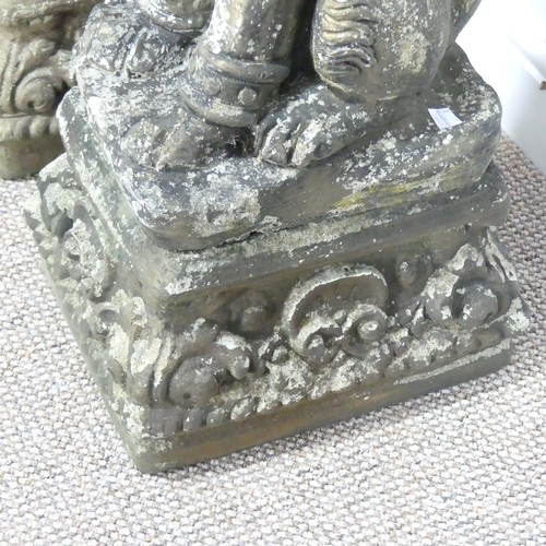 554 - Garden statuary; a pair of reconstituted stone figures of Dogs of Foo, each sat upon a plinth, 65cm ... 