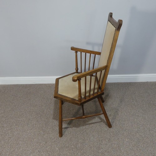 282 - An Arts & Crafts oak framed hexagonal Chair, with tall comb back and arms on spindle supports, r... 