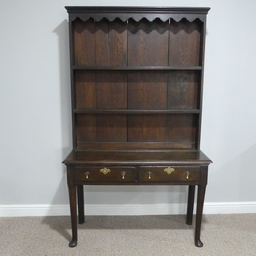 340 - An early 19th century oak dresser with plate rack, with shaped cornice and two shelves above two dra... 