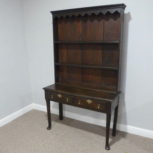 340 - An early 19th century oak dresser with plate rack, with shaped cornice and two shelves above two dra... 