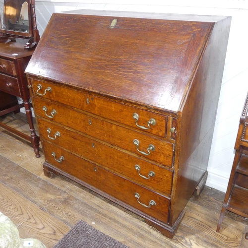 341 - A George III oak Bureau, the fall front enclosing a inlaid fitted interior, raised on four drawers, ... 