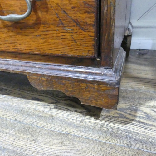 341 - A George III oak Bureau, the fall front enclosing a inlaid fitted interior, raised on four drawers, ... 