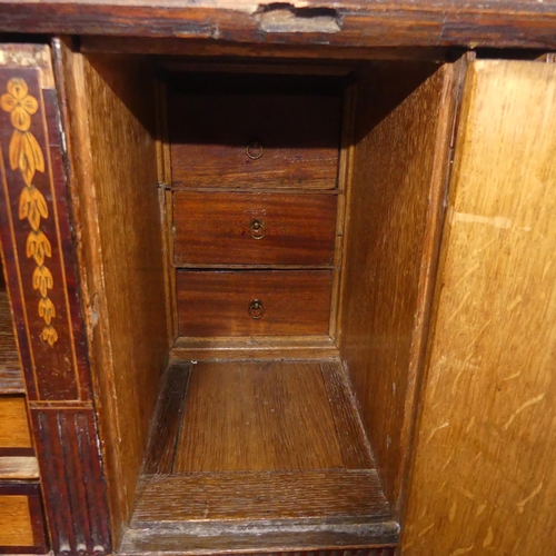 341 - A George III oak Bureau, the fall front enclosing a inlaid fitted interior, raised on four drawers, ... 