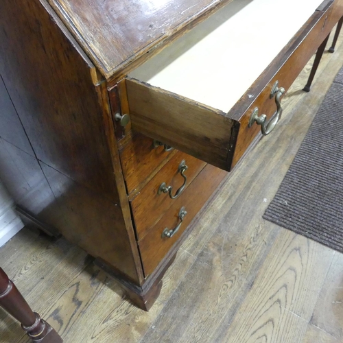 341 - A George III oak Bureau, the fall front enclosing a inlaid fitted interior, raised on four drawers, ... 