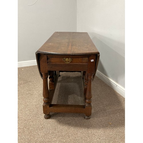 344 - An Oak Gateleg Table, with a drawer to either end on turned legs, split to top, W 149cm x D 130cm x ... 