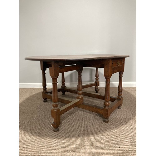 344 - An Oak Gateleg Table, with a drawer to either end on turned legs, split to top, W 149cm x D 130cm x ... 