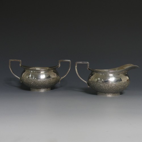 414 - An Indian silver Cream Jug and Sugar Bowl, unmarked but tested, with typical ornate decora... 