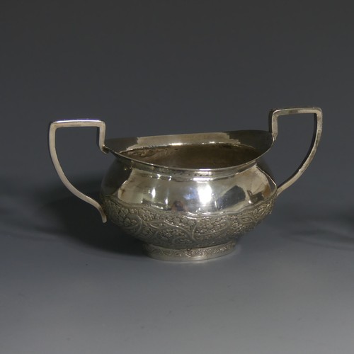 414 - An Indian silver Cream Jug and Sugar Bowl, unmarked but tested, with typical ornate decora... 