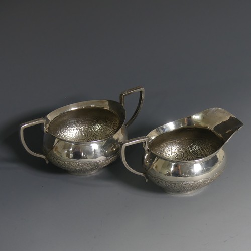 414 - An Indian silver Cream Jug and Sugar Bowl, unmarked but tested, with typical ornate decora... 