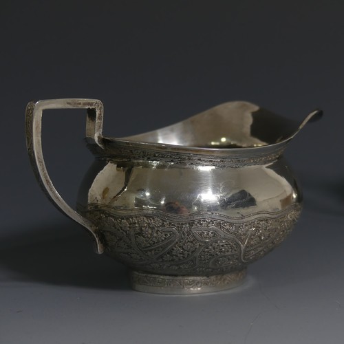 414 - An Indian silver Cream Jug and Sugar Bowl, unmarked but tested, with typical ornate decora... 