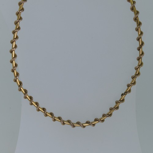 127 - A 9ct yellow gold Necklace, formed of a ropetwist chain wrapped around a polished chain, clip clasp,... 