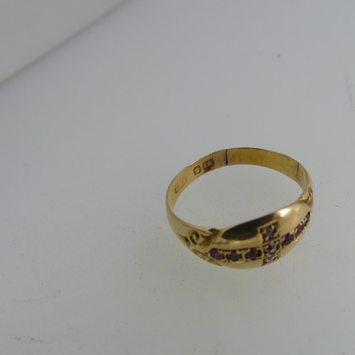 78 - A 9ct yellow gold Ring, the front with two gypsy set rubies and seed pearl centre, engraved shoulder... 