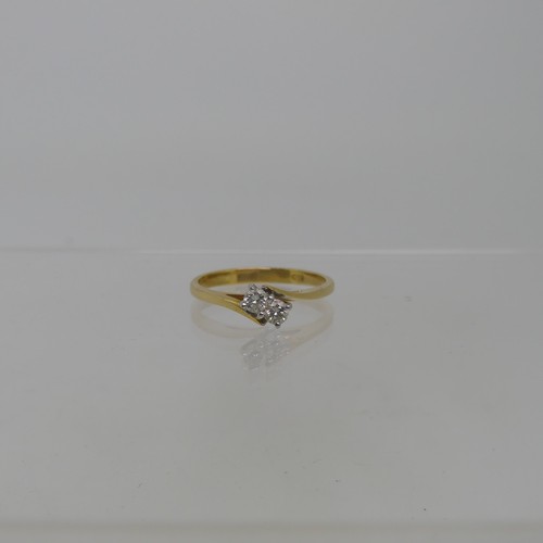 91 - A two stone diamond Ring, set on the cross in 18ct yellow and white gold, each stone approx 0.075ct,... 