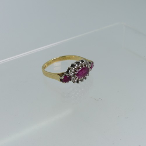 100 - A ruby and diamond cluster Ring, the oval central ruby claw set in white gold within a surround of f... 