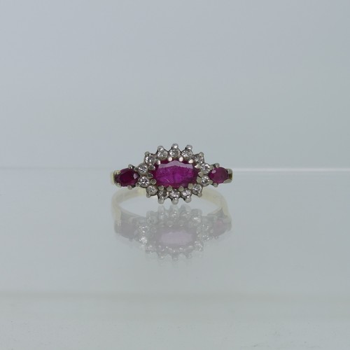 100 - A ruby and diamond cluster Ring, the oval central ruby claw set in white gold within a surround of f... 