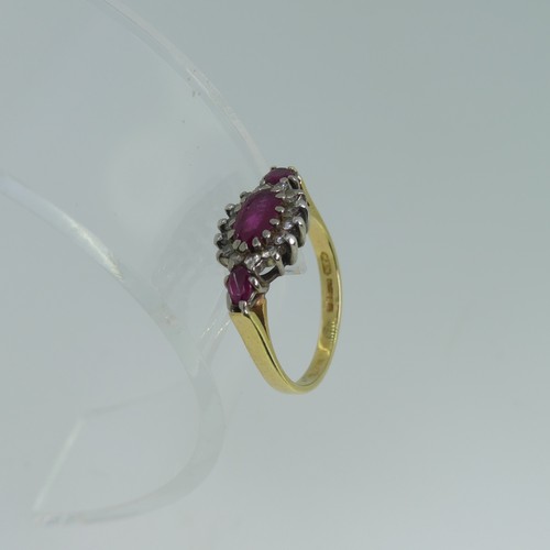 100 - A ruby and diamond cluster Ring, the oval central ruby claw set in white gold within a surround of f... 