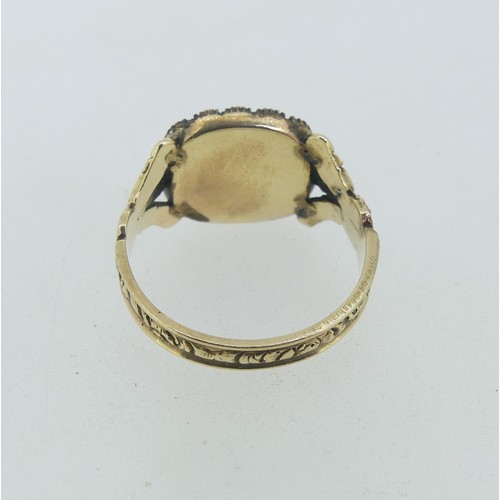 83 - An early 19thC Mourning Ring, the squared front with central panel set woven hair within a seed pear... 