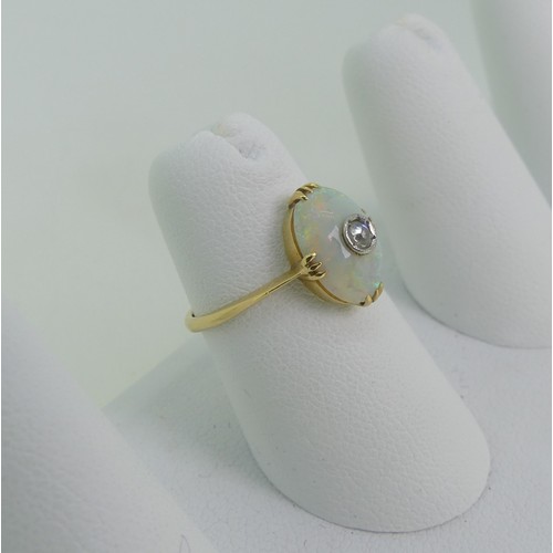 86 - A small opal and diamond Ring, the oval opal 10.5mm x 7.5mm, set with a diamond point centre, all mo... 