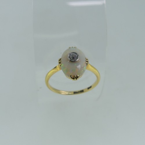 86 - A small opal and diamond Ring, the oval opal 10.5mm x 7.5mm, set with a diamond point centre, all mo... 