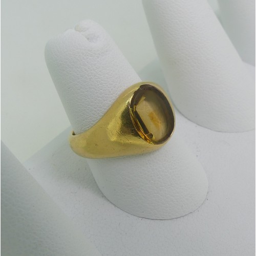 90 - A citrine Signet Ring, the oval stone mounted in unmarked yellow gold, tested as 18ct, Size O½, appr... 