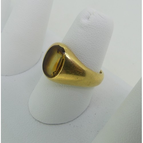 90 - A citrine Signet Ring, the oval stone mounted in unmarked yellow gold, tested as 18ct, Size O½, appr... 