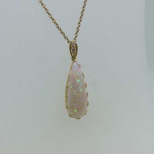 123 - An opal tear drop shaped Pendant, the stone 30mm long, mounted in 18ct yellow gold, the suspension l... 