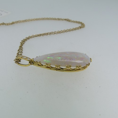 123 - An opal tear drop shaped Pendant, the stone 30mm long, mounted in 18ct yellow gold, the suspension l... 