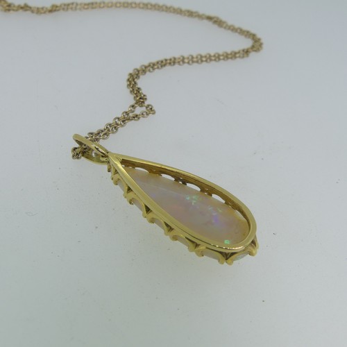 123 - An opal tear drop shaped Pendant, the stone 30mm long, mounted in 18ct yellow gold, the suspension l... 