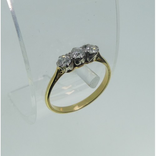 66 - A small three stone diamond Ring, the unmarked yellow gold shank tested as 18ct gold, Size O, approx... 