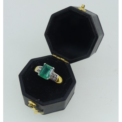 94 - An 18ct yellow gold and emerald Ring, the emerald cut stone claw set in white gold with four small d... 