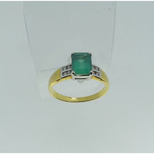 94 - An 18ct yellow gold and emerald Ring, the emerald cut stone claw set in white gold with four small d... 