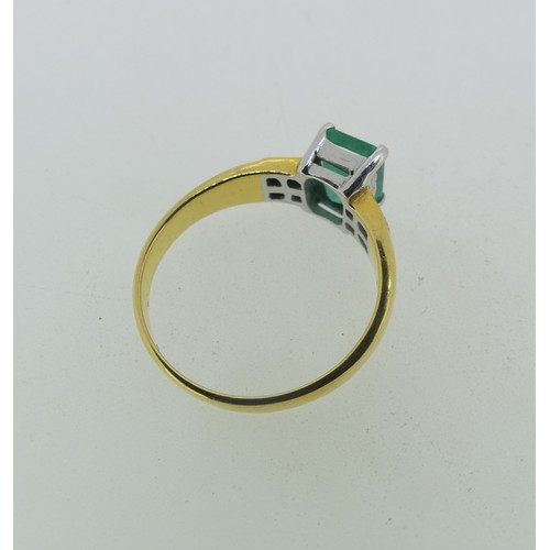 94 - An 18ct yellow gold and emerald Ring, the emerald cut stone claw set in white gold with four small d... 