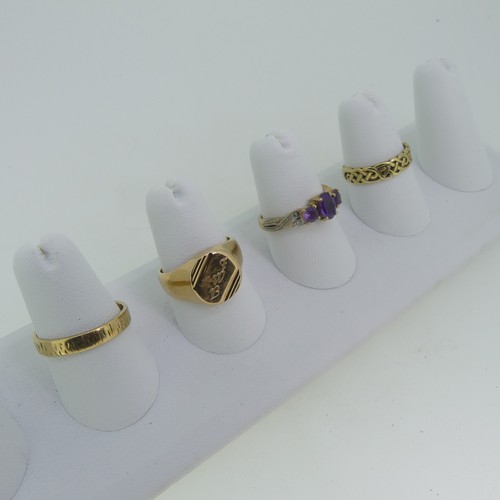 92 - Three 9ct gold Rings; one a textured band, Size O½, one set amethysts, Size O, one with knot front, ... 