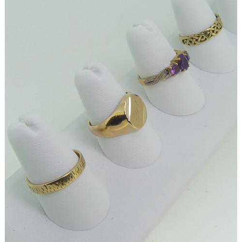 92 - Three 9ct gold Rings; one a textured band, Size O½, one set amethysts, Size O, one with knot front, ... 