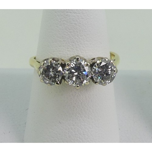 114 - A three stone Diamond Ring, the circular cut centre stone approx 0.56ct, with  a circular cut stone ... 