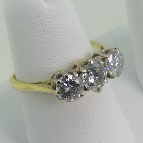 114 - A three stone Diamond Ring, the circular cut centre stone approx 0.56ct, with  a circular cut stone ... 