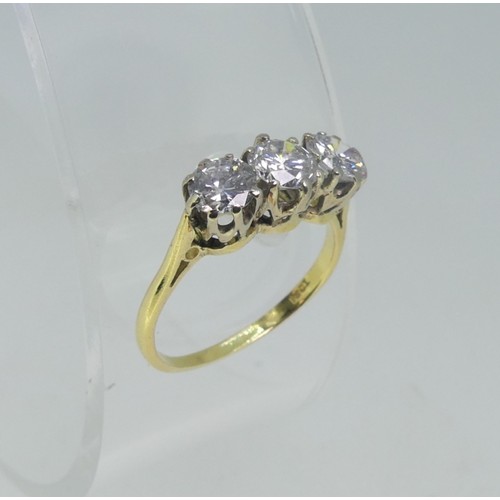 114 - A three stone Diamond Ring, the circular cut centre stone approx 0.56ct, with  a circular cut stone ... 