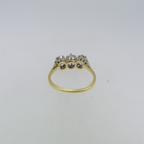 114 - A three stone Diamond Ring, the circular cut centre stone approx 0.56ct, with  a circular cut stone ... 