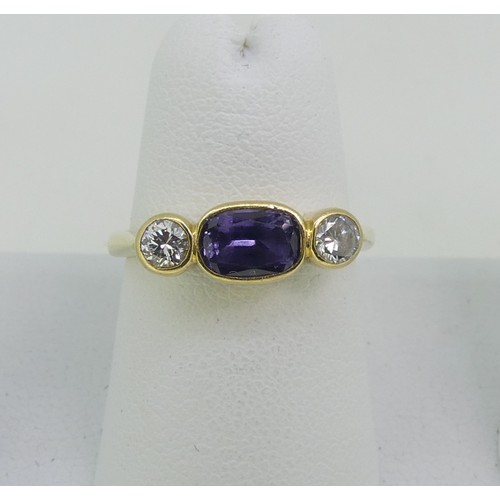 113 - A colour change sapphire and diamond three stone Ring, the central oval sapphire, approx 1ct, with a... 