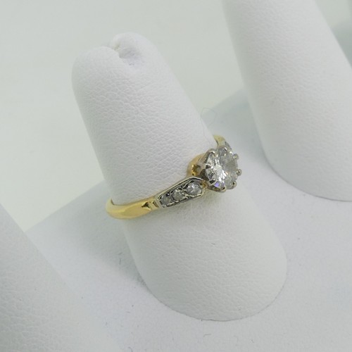 115 - A single stone diamond Ring, the circular cut stone approx 0.52ct, with three graduated small diamon... 