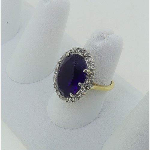 106 - An amethyst and diamond Dress Ring, the oval facetted amethyst surrounded by twenty small diamond po... 