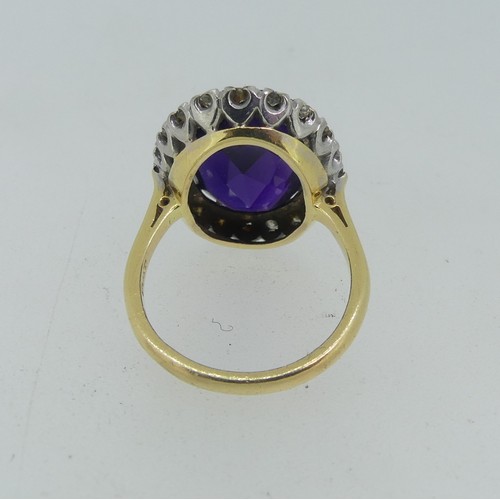 106 - An amethyst and diamond Dress Ring, the oval facetted amethyst surrounded by twenty small diamond po... 