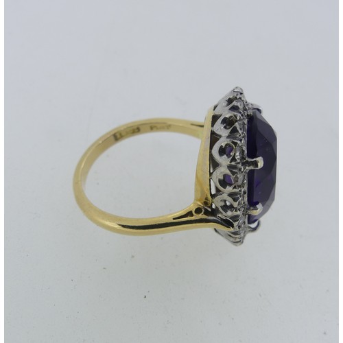 106 - An amethyst and diamond Dress Ring, the oval facetted amethyst surrounded by twenty small diamond po... 