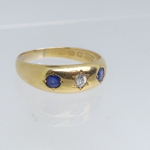 111 - An 18ct yellow gold Band, gypsy set with two sapphires and central diamond, the diamond approx 0.1ct... 