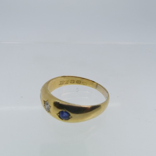 111 - An 18ct yellow gold Band, gypsy set with two sapphires and central diamond, the diamond approx 0.1ct... 