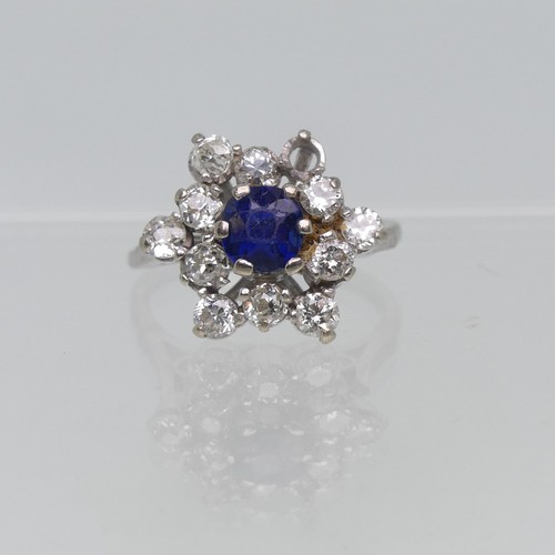 72 - A sapphire and diamond cluster Ring, the central circular facetted sapphire surrounded by eleven dia... 