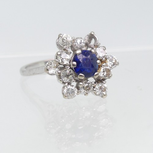 72 - A sapphire and diamond cluster Ring, the central circular facetted sapphire surrounded by eleven dia... 