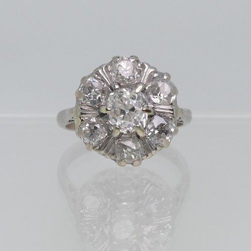 73 - A diamond cluster Ring, the central stone approx. 0.4ct, claw set above a surround of six further di... 