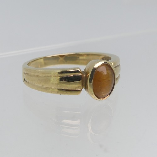 74 - A 9ct yellow gold Signet Ring, collet set with an oval Tiger's Eye, Size T, 4.5g.